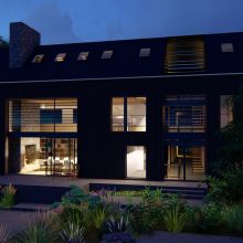 Night time visual showing the glowing windows on the back elevation